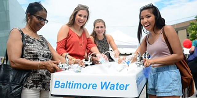 Women smiling and laughing at a Baltimore Water event